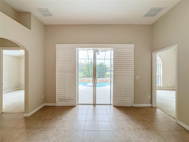 doorway featuring light tile patterned floors and a wealth of natural light