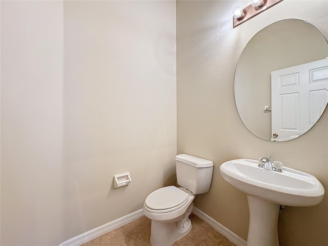 bathroom with tile patterned flooring and toilet