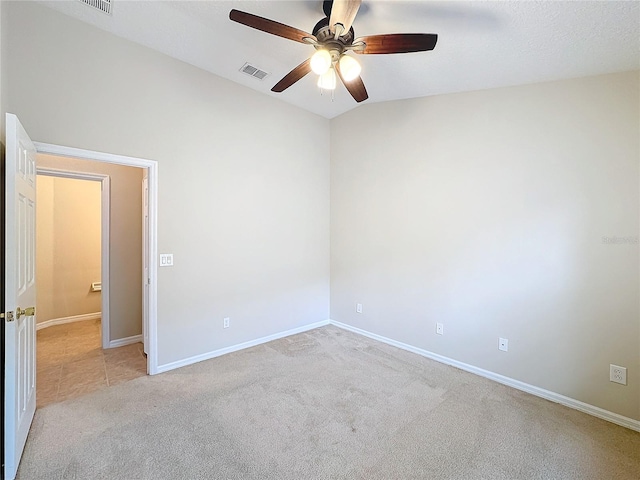 unfurnished room with ceiling fan, light colored carpet, and vaulted ceiling