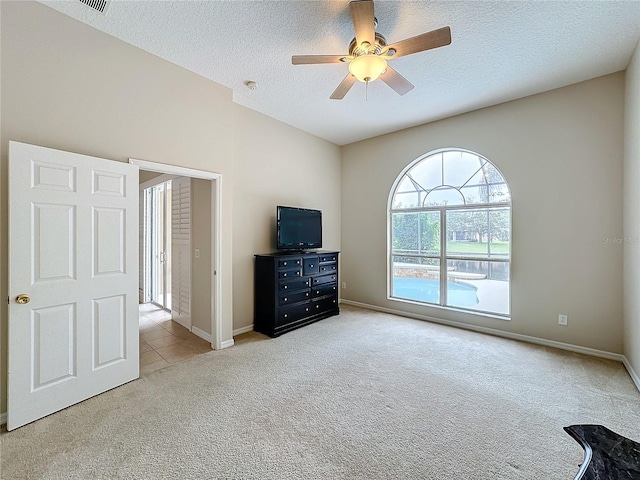 interior space with light carpet, a textured ceiling, and ceiling fan