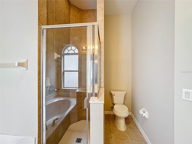 bathroom with tile patterned floors, toilet, and shower with separate bathtub