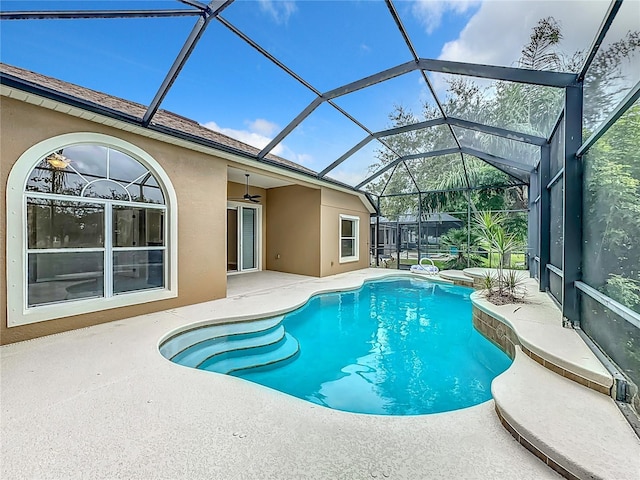 view of swimming pool with a patio, ceiling fan, and a lanai