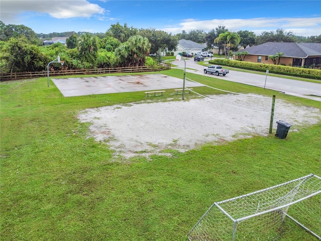 view of community with a lawn and basketball court