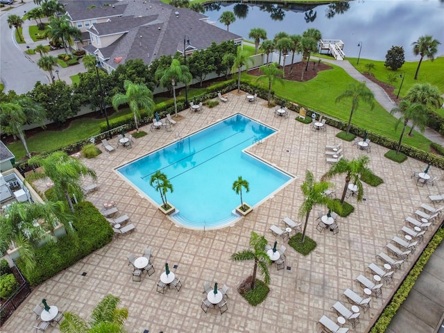 view of swimming pool featuring a patio and a water view