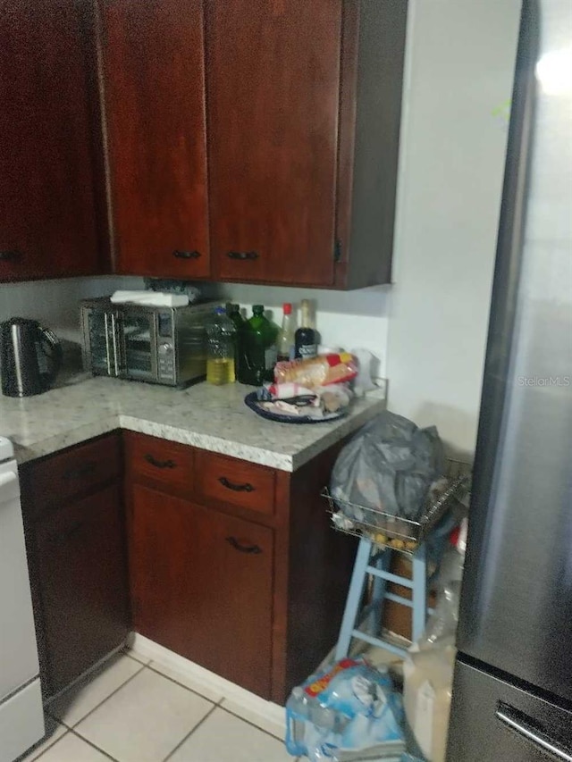 kitchen featuring stainless steel fridge and light tile patterned flooring