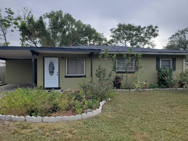 ranch-style house with a carport and a front yard