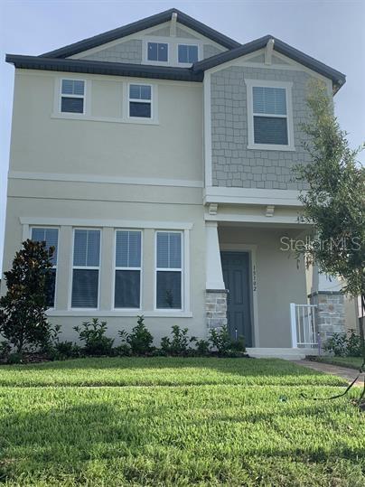 craftsman-style home with a front lawn