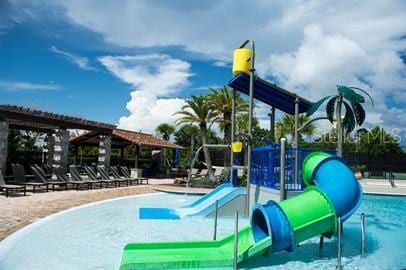 view of jungle gym featuring a community pool