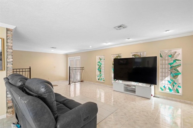 living room with ornamental molding, a textured ceiling, and light tile patterned floors