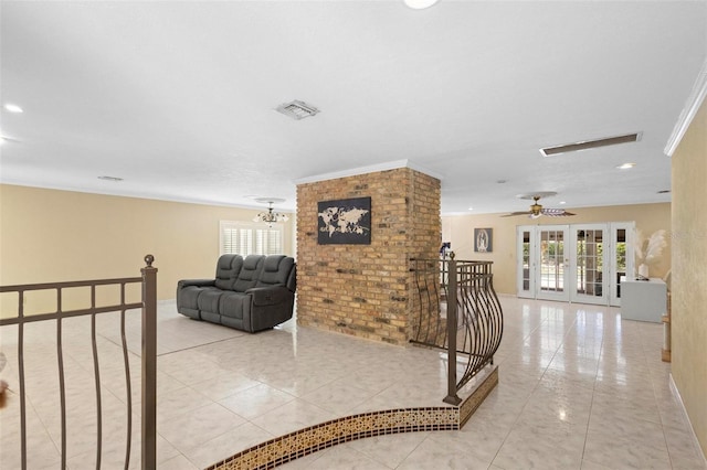 corridor featuring an inviting chandelier, light tile patterned floors, french doors, and crown molding