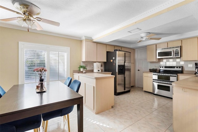 kitchen featuring stainless steel appliances, backsplash, and a textured ceiling