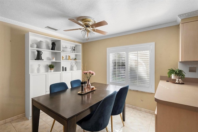 dining space featuring a textured ceiling, crown molding, light tile patterned flooring, and ceiling fan