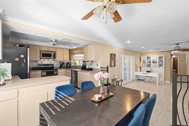 dining room with a textured ceiling, crown molding, light tile patterned flooring, and sink