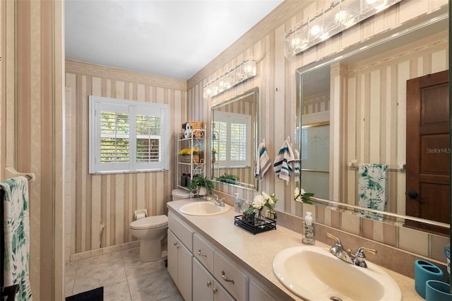 bathroom with tile patterned flooring, vanity, and toilet