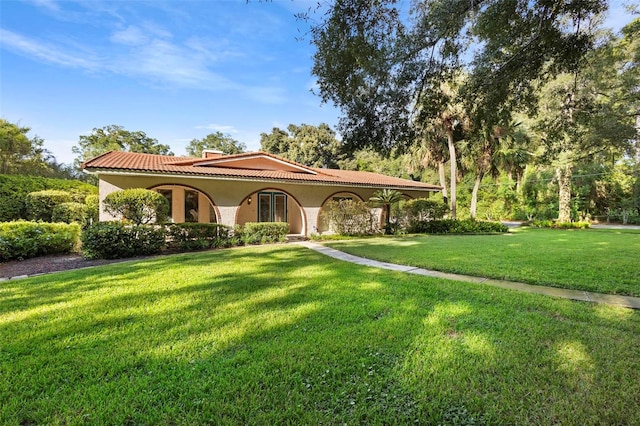 mediterranean / spanish house with a front yard