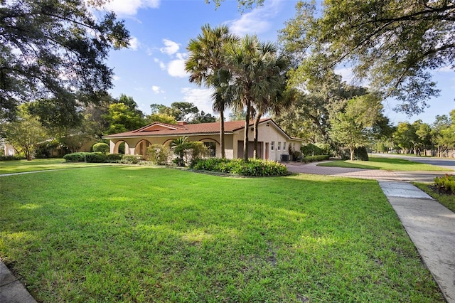 mediterranean / spanish home with a front yard