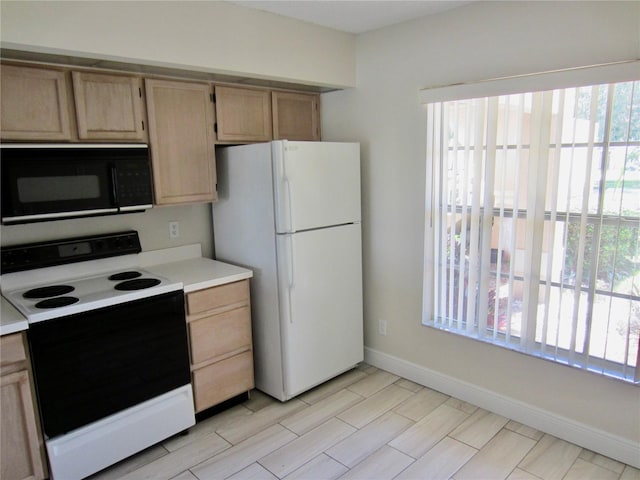 kitchen with light brown cabinets and white appliances