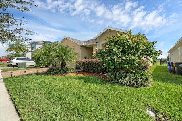 view of side of property with a lawn