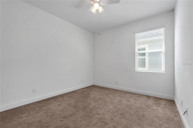 carpeted empty room featuring ceiling fan