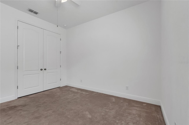 unfurnished bedroom featuring carpet, a closet, and ceiling fan