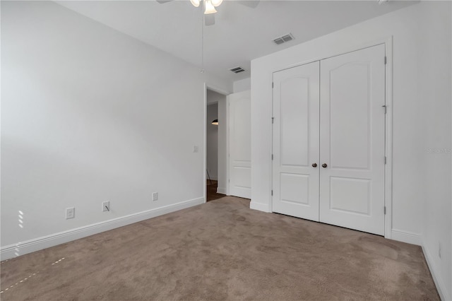 unfurnished bedroom with a closet, ceiling fan, and carpet floors