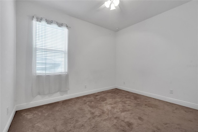 carpeted empty room featuring ceiling fan