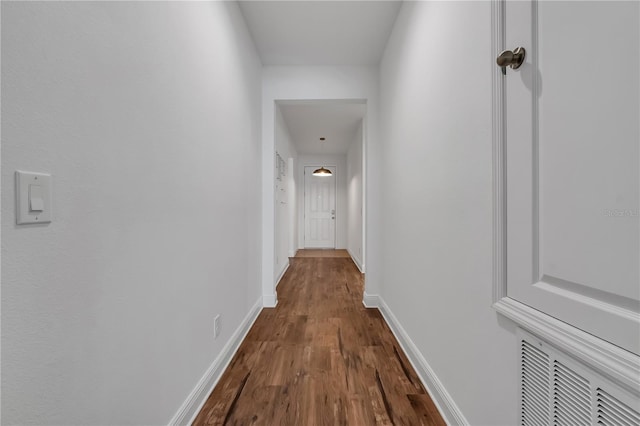 corridor with dark hardwood / wood-style flooring