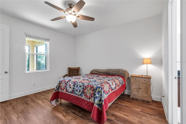 bedroom with hardwood / wood-style flooring and ceiling fan