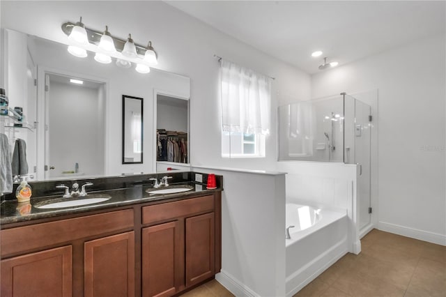 bathroom featuring vanity, shower with separate bathtub, and tile patterned floors