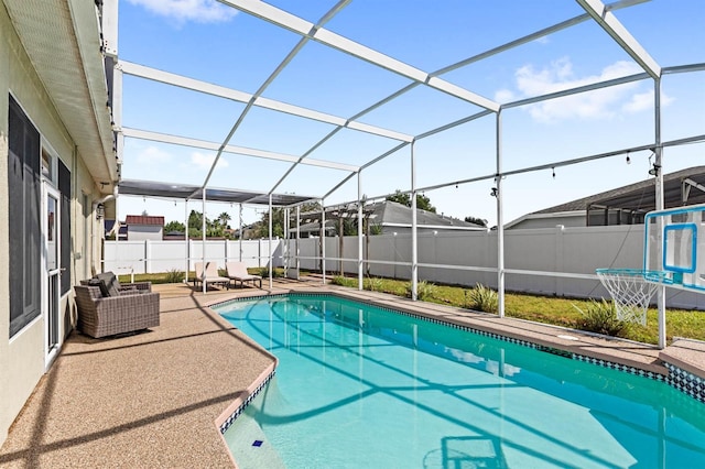 view of pool featuring a patio and glass enclosure