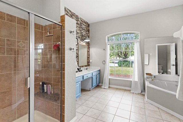 full bathroom featuring vanity, plus walk in shower, tile patterned floors, and a wealth of natural light