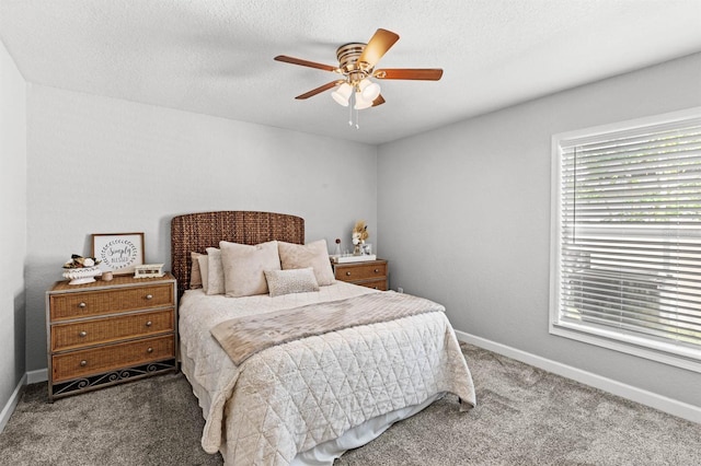 bedroom with a textured ceiling, carpet flooring, and ceiling fan