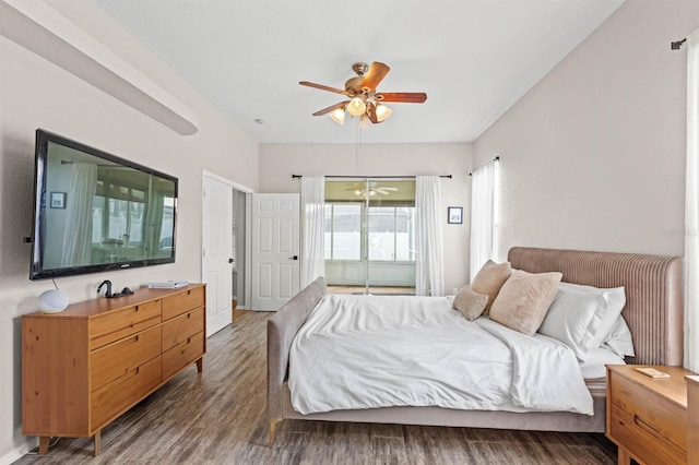 bedroom with dark hardwood / wood-style flooring and ceiling fan