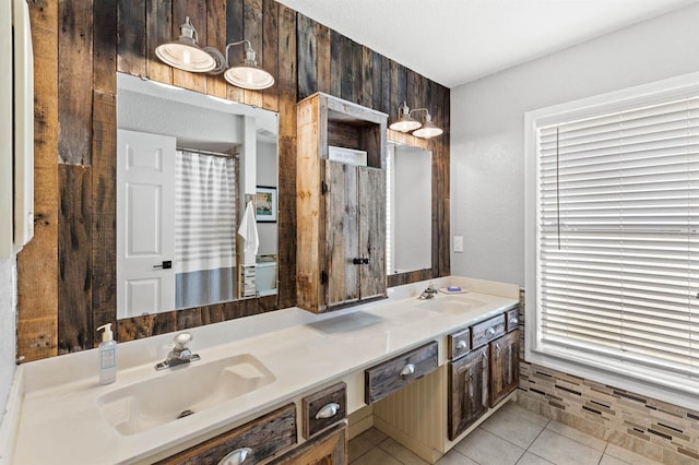 bathroom with vanity, wood walls, a textured ceiling, and tile patterned floors