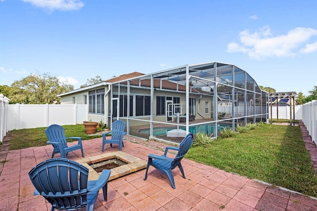 view of patio / terrace with glass enclosure and a fenced in pool