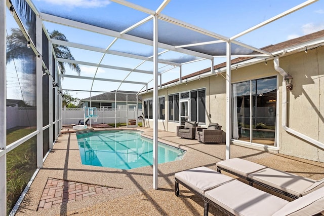 view of swimming pool with a lanai and a patio