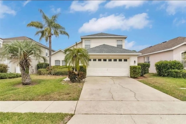 view of property with a front yard and a garage