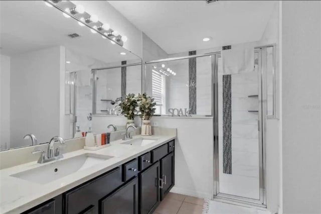 bathroom featuring tile patterned floors, an enclosed shower, and vanity