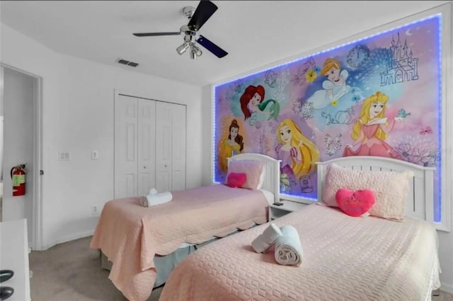 bedroom featuring light carpet, a closet, and ceiling fan