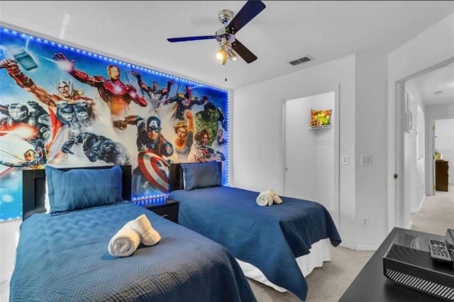 bedroom with ceiling fan and light carpet