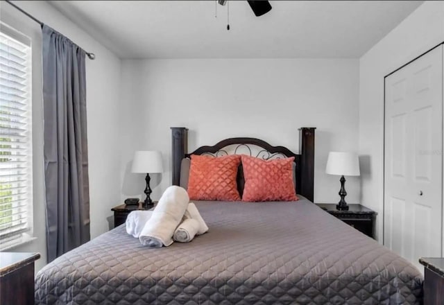 bedroom with ceiling fan and a closet