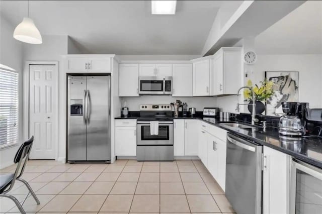 kitchen featuring wine cooler, sink, white cabinets, appliances with stainless steel finishes, and decorative light fixtures