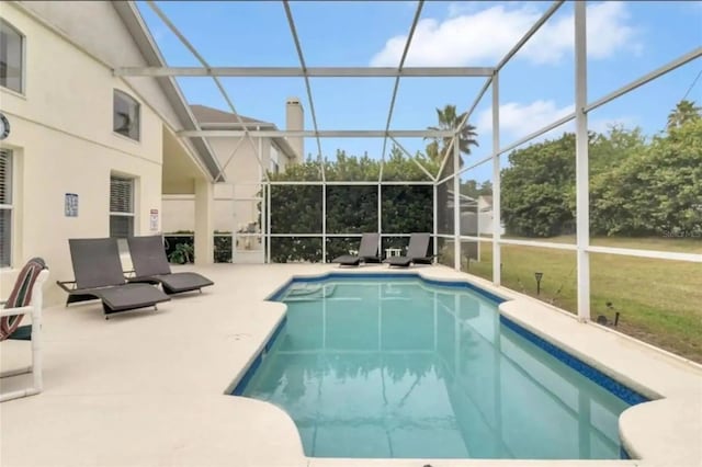 view of pool with a yard, a lanai, and a patio area