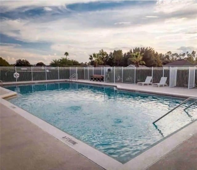 view of pool at dusk