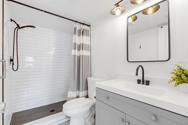 full bathroom featuring toilet, a stall shower, and vanity