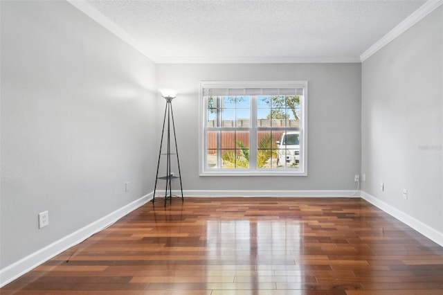 spare room featuring a textured ceiling, baseboards, and wood finished floors