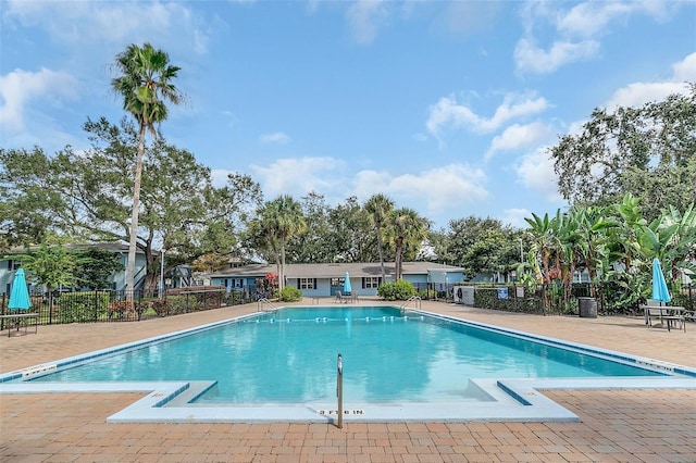 pool featuring a patio area and fence