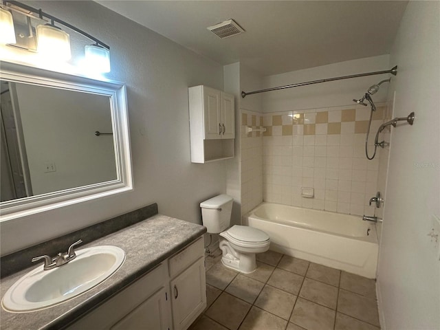 full bathroom with vanity, tile patterned flooring, toilet, and tiled shower / bath