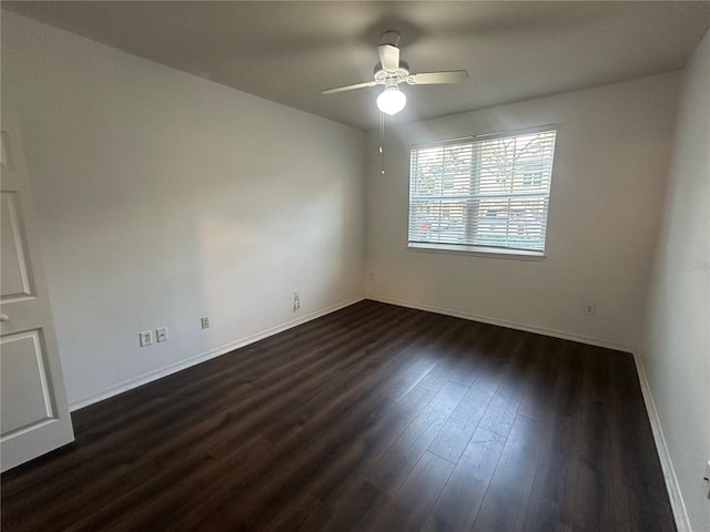 spare room featuring ceiling fan and dark hardwood / wood-style floors