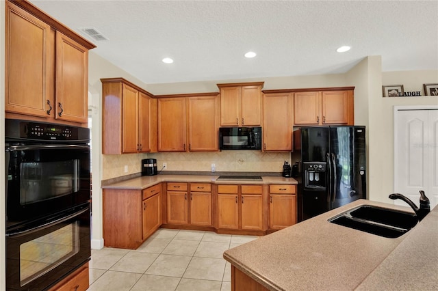 kitchen featuring light tile patterned flooring, sink, tasteful backsplash, a textured ceiling, and black appliances